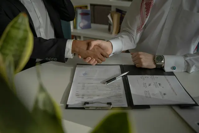 Advisor and client reviewing documents across a desk